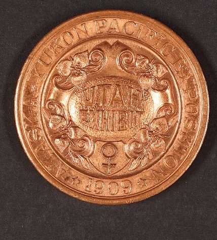 Front of a copper medallion from the Alaska-Pacific-Yukon Exposition.