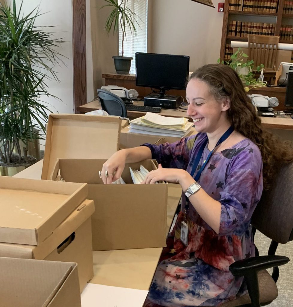 Archives staff member Lauren works on accessioning records