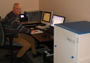 Brian Carpenter working on a computer next to the Staude SMA digital film converter 