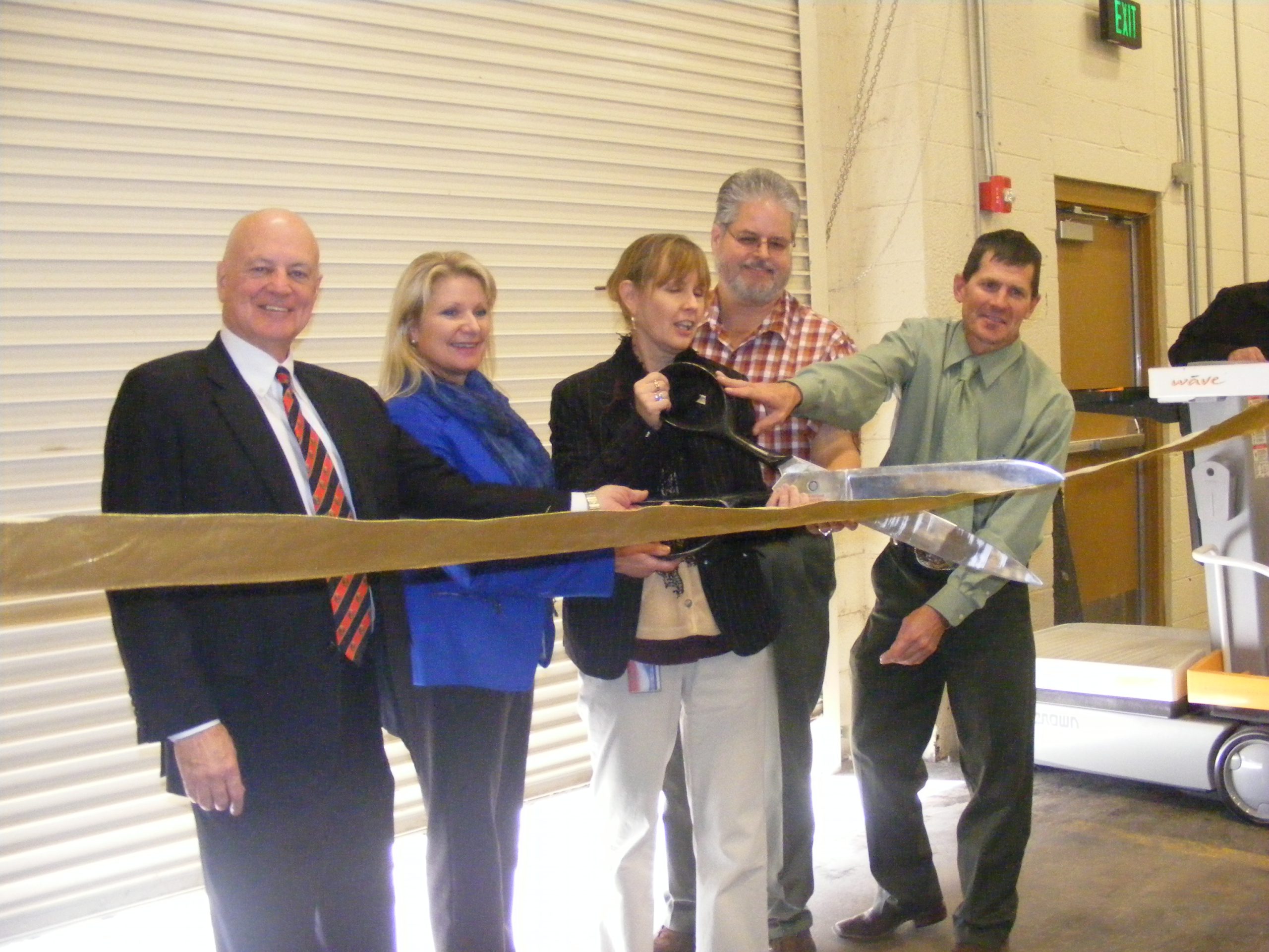 Photograph of 5 individuals cutting the ribbon at the Utah State Records Center Ribbon Cutting, 2012. 