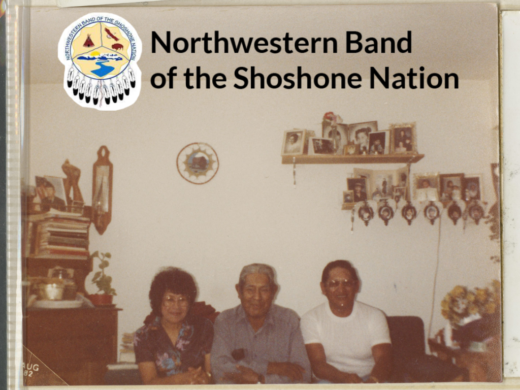 Photo of Pasculita Peyope Blood, Wilford Peyope, and Glen Peyope sitting on a couch in a row facing the camera. The walls are decorated with crafts and photographs.