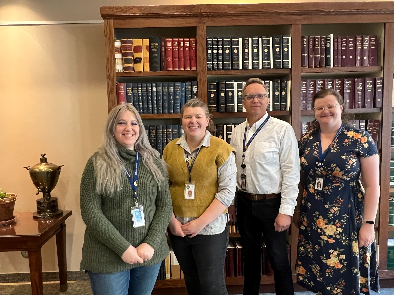 Four members of the Local Government team standing in the State Archives Reference Room.