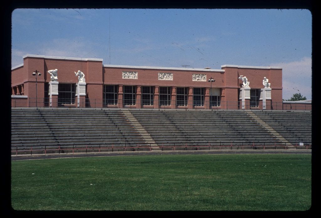 The Technical Building had similar facades facing both east and west. Bleachers for the football stadium later blocked the view of the lower floor on the east, but the sculptures were still visible and could be viewed close-up from the top of the bleachers. The panels and figures were identical to those on the west side of the building. (State Historic Preservation Office photo, Utah State Archives, Series 30306.)