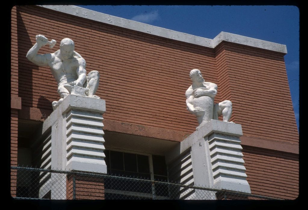 On the north end of the façade behind the stadium stood Mahonri Young’s muscular sculptures of the blacksmith and the potter.