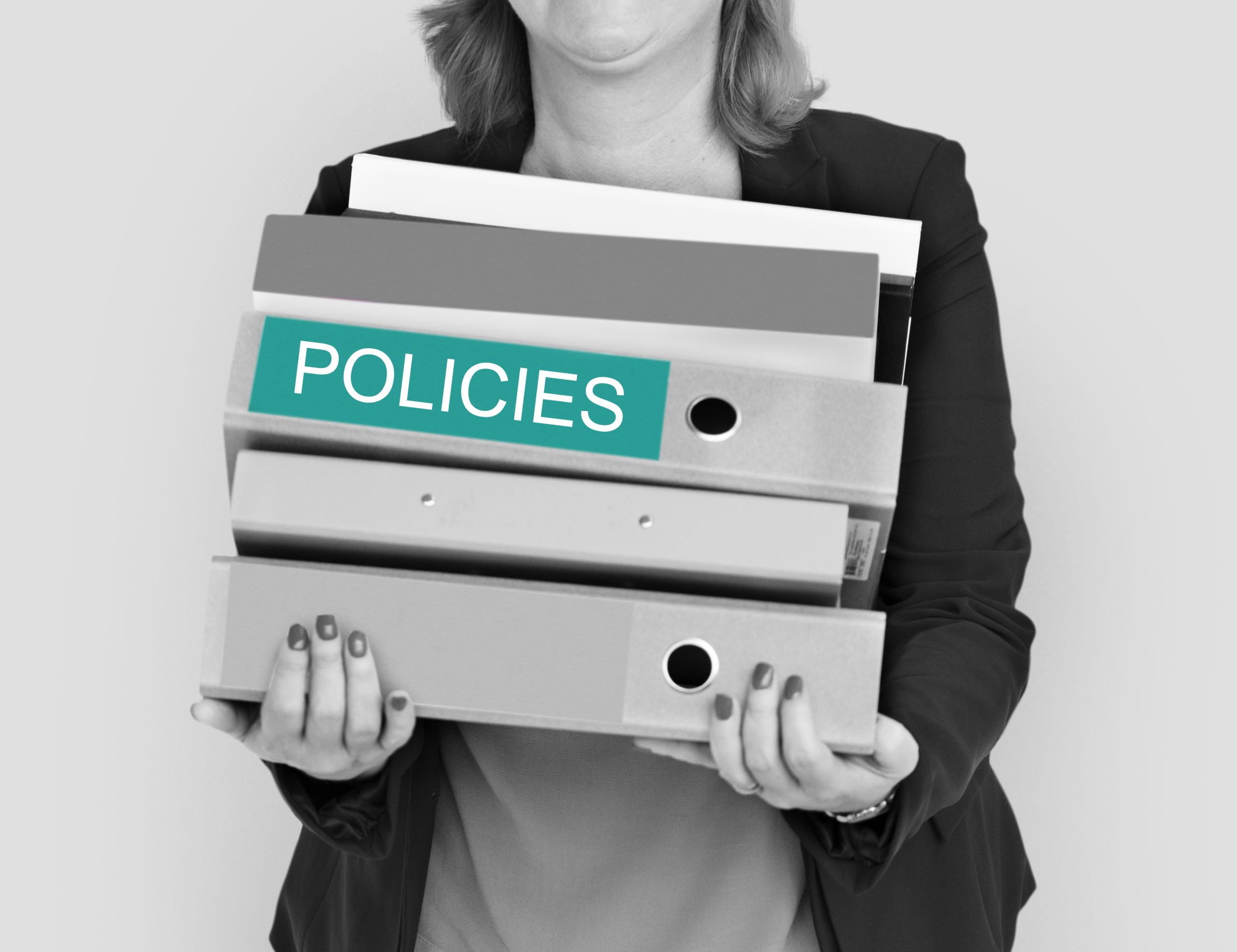 woman carrying binders for policies