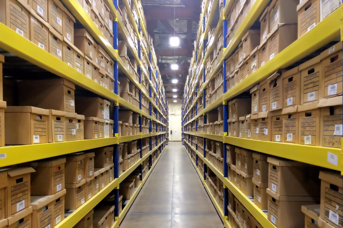 Long row in a warehouse filled from top to bottom with boxes containing files